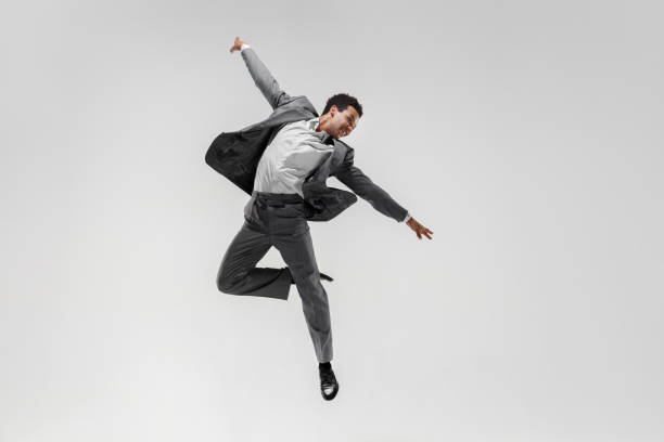 istock Happy businessman dancing isolated on gray studio background 1132239781