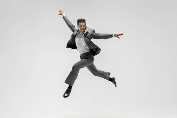 istock Happy businessman dancing isolated on gray studio background 1132239787