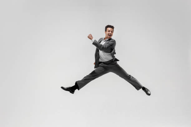 istock Happy businessman dancing isolated on gray studio background 1132239788