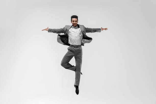 istock Happy businessman dancing isolated on gray studio background 1132239791