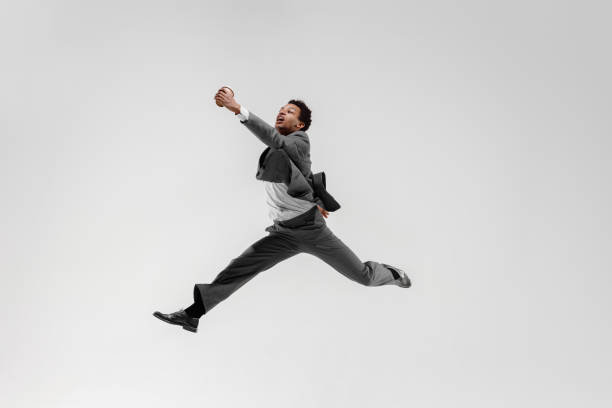istock Happy businessman dancing isolated on gray studio background 1132239794