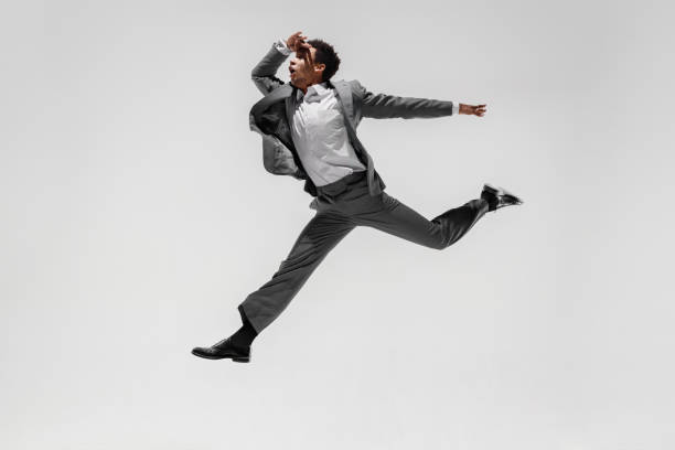 istock Happy businessman dancing isolated on gray studio background 1132239802