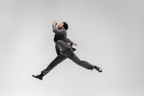 istock Happy businessman dancing isolated on gray studio background 1132239809