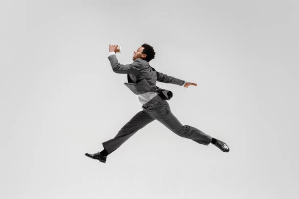 istock Happy businessman dancing isolated on gray studio background 1132239814