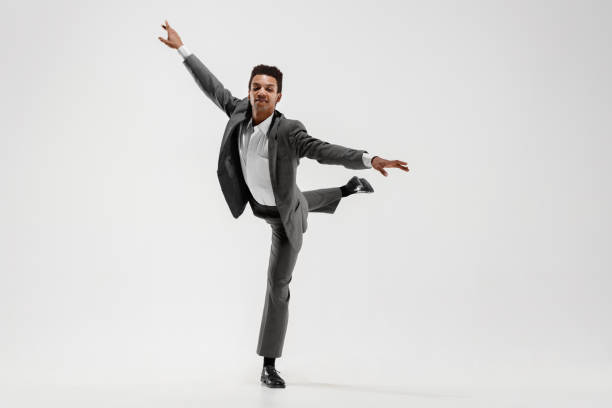 istock Happy businessman dancing isolated on gray studio background 1132239818
