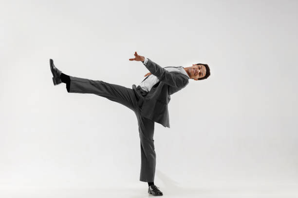 istock Happy businessman dancing isolated on gray studio background 1132239829