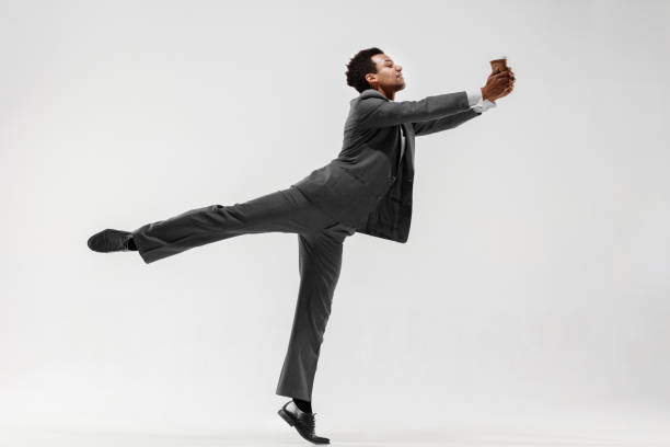 istock Happy businessman dancing isolated on gray studio background 1132239846