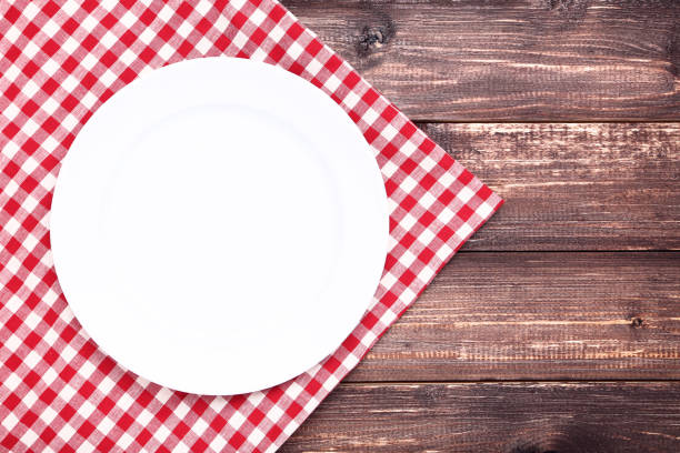 istock White plate with red napkin on brown table 1132239857