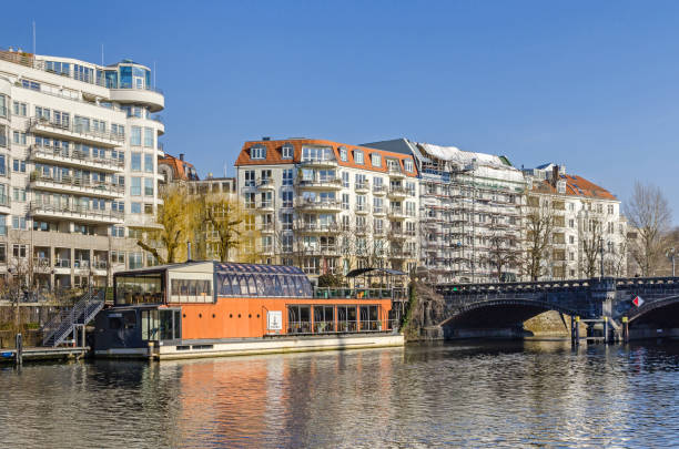River Spree and the Spree-Bogen with the residential buildings, the restaurantship PATIO and Moabiter bridge Berlin, Germany - February 14, 2019: River Spree embankment Helgolaender Ufer with the Moabiter bridge and the newly designed area Spree-Bogen with the residential buildings and the restaurantship PATIO moabit stock pictures, royalty-free photos & images