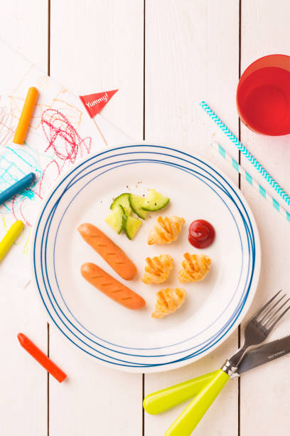 istock Kid's breakfast - weenies, mini croissants and cucumber 1132244007