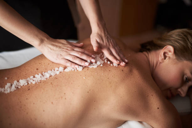 istock Female therapist put mineral salt on lady back 1132244419
