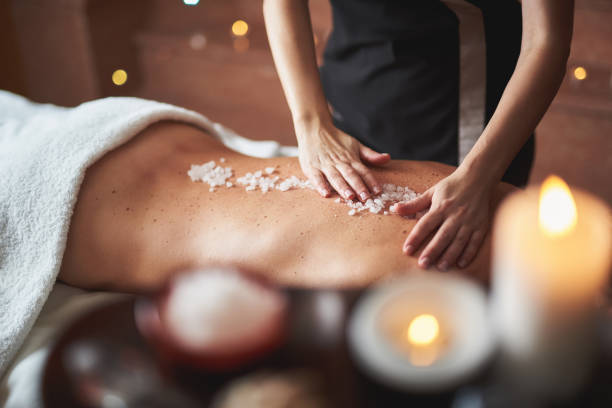 istock Therapist apply mineral salt on lady back 1132244436