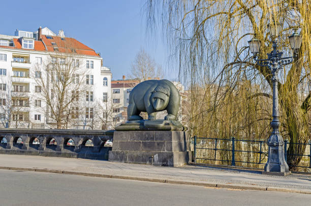 Moabiter bridge over the River Spree with the bear sculpture  in a city district Moabit in Berlin, Germany Berlin, Germany - February 14, 2019: Moabiter bridge, a stone bridge over the River Spree with one of four cast iron bear sculptures by Guenter Anlauf in a city district Moabit in Berlin, Germany moabit stock pictures, royalty-free photos & images