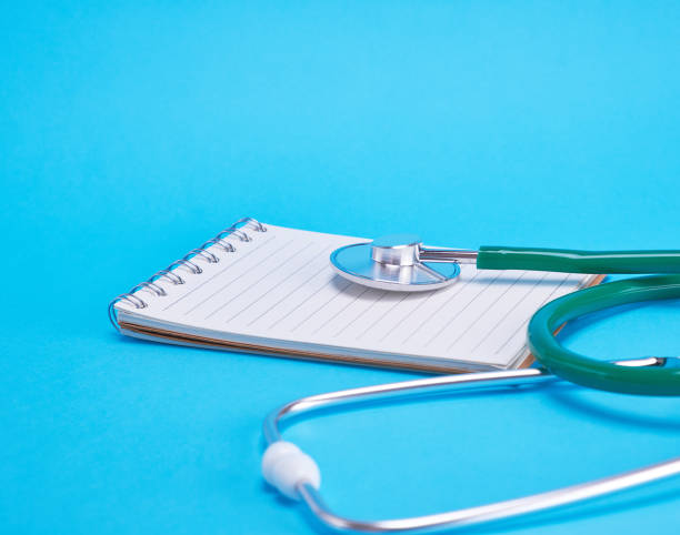 istock green medical stethoscope and empty paper notebook 1132244926