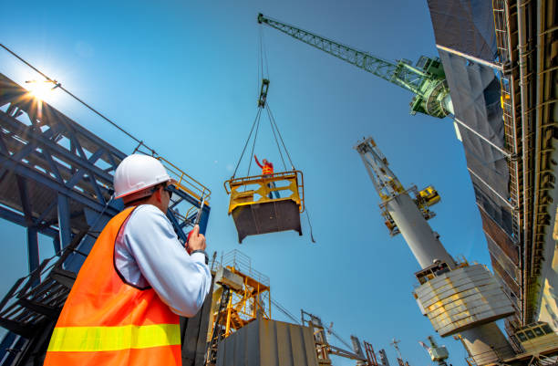 Takes a risk at work foreman, supervisor, worker, loading master in works at job site, control to the teamwork by walkie talkie radio for job done in the same direction, working at risk and high level of insurance"n railing photos stock pictures, royalty-free photos & images