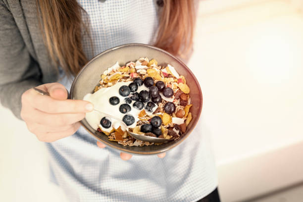 istock School girl eating healthy breakfast. 1132246282