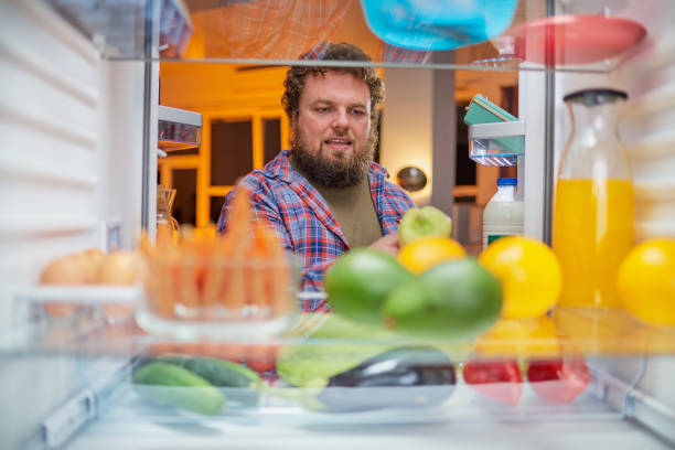 istock Man looking for something to eat at night. 1132247175