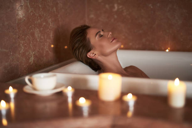istock Smiling lady take relaxed spa bath with candle 1132248326