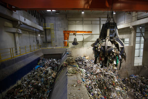 istock Mechanical claw hand grabbing pile of mixed waste 1132250259