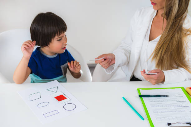 istock Female Therapist Sitting With Boy At Table In Room 1132250683