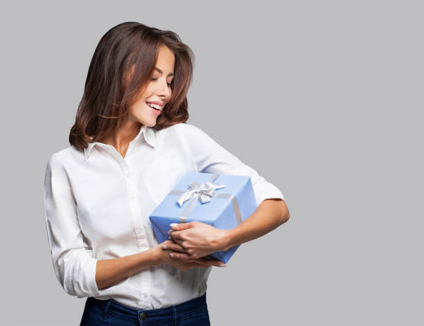istock Happy woman holding a gift box 1132251080