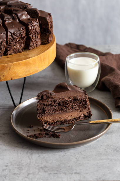 istock Slice of chocolate cake on gray plate with fork 1132252086