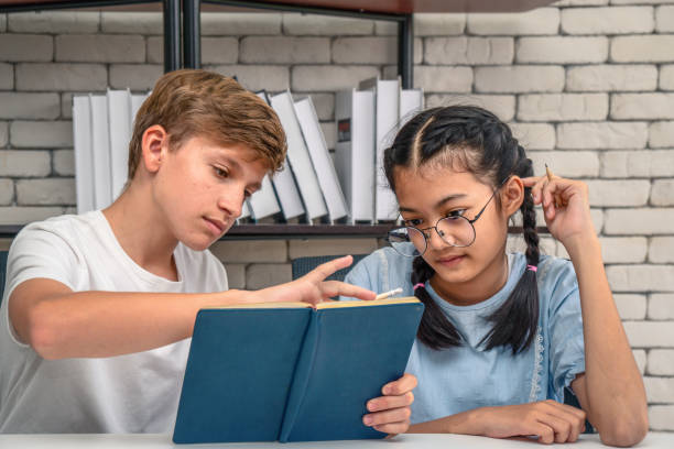 istock teenage students doing homework together 1132252410