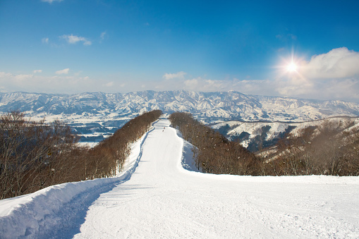 Landscape and Mountain view of Nozawa Onsen in winter with sunrise background  , Nagano, Japan.