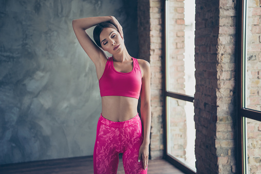 Portrait of nice slender beautiful attractive thin concentrated focused dreamy gorgeous lady doing work-out class dance in modern loft industrial interior style indoors.