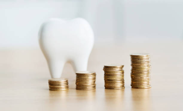 Coins and tooth model on table Coins and tooth model on table. chinese yuan coin stock pictures, royalty-free photos & images