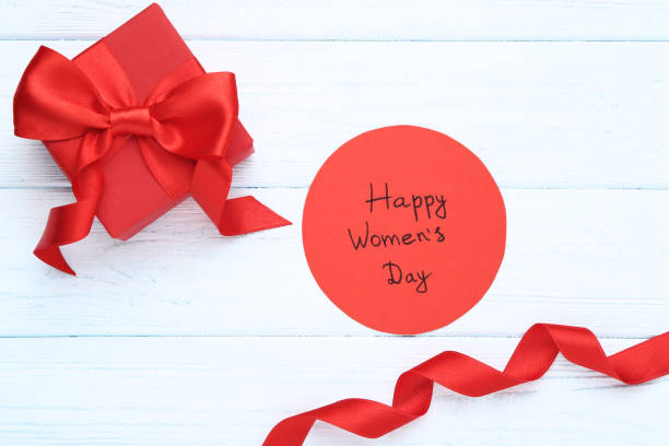istock Text Happy Women's Day with red gift box on wooden table 1132255879