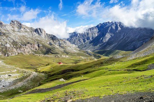 Fuente De in the in mountains of Picos de Europa, Cantabria, Spain. In the heart of the Picos de Europa, we find impressive landscapes of valleys and green meadows, rocky mountains and grazing cattle.