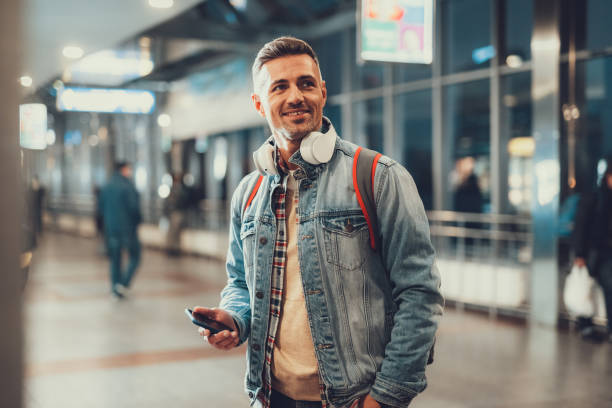 istock Man holding telephone and ready flying on trip 1132256314