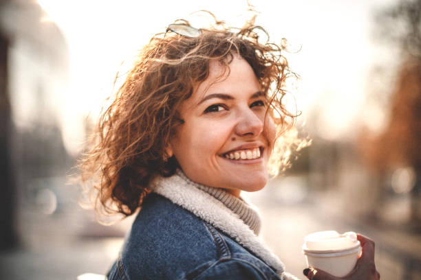 istock Curly girl drinking coffee 1132256389