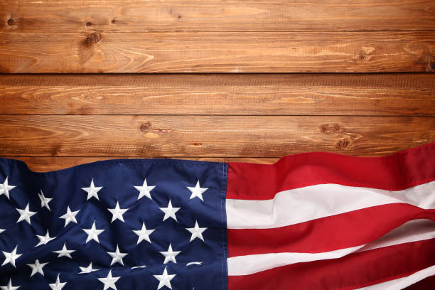istock American flag on brown wooden table 1132256534