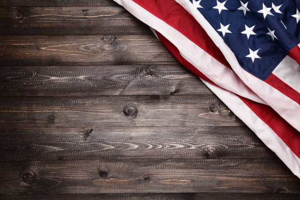 American flag on brown wooden table stock photo