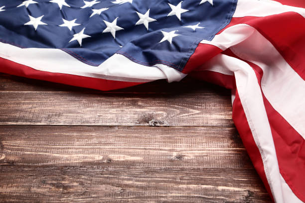istock American flag on brown wooden table 1132256936