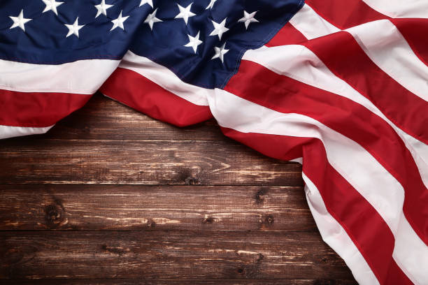 istock American flag on brown wooden table 1132257995