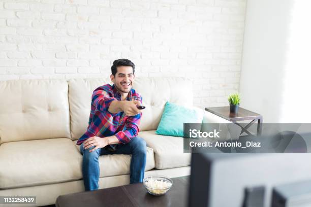 Man Watching Tv During His Leisure Time Stock Photo - Download Image Now - Men, Television Industry, Television Set