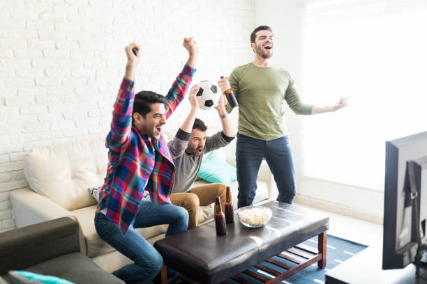 istock Men Having Fun While Watching Football Game At Home 1132258523