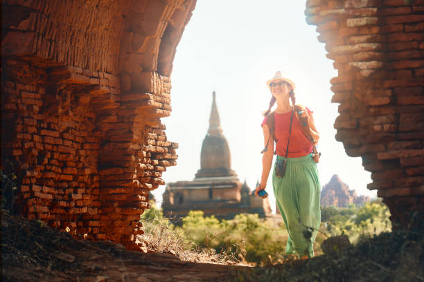 istock woman traveler with a backpack walking through the Old Bagan looking the ancient Buddhist stupas. Myanmar. 1132258707