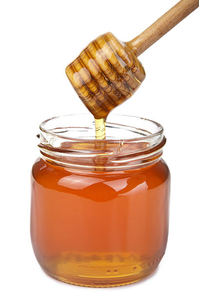 istock honey pouring in jar isolated 113226072