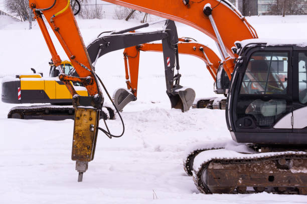 istock dance of excavators in the snow 1132260770