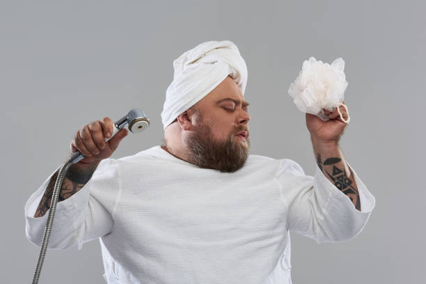 istock Relaxed funny man dancing with shower head and shower puff 1132261561