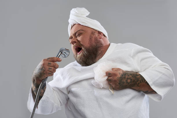 istock Creative funny man closing his eyes and singing in shower 1132261568