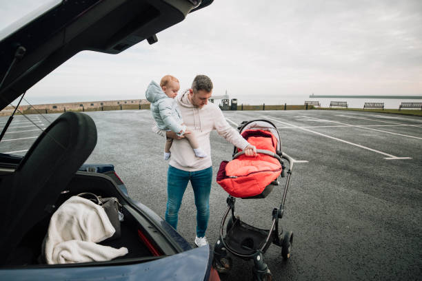 istock Multi-tasking Father in the Parking Lot 1132261739
