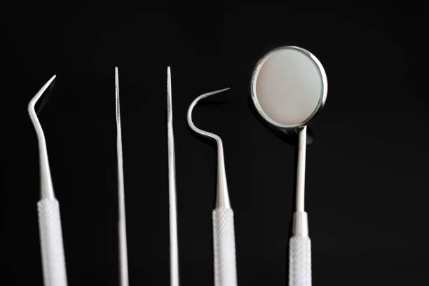 istock Dentist medical tools on black background 1132261873