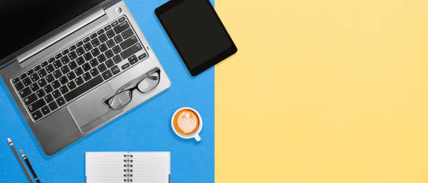 istock Working space office desktop with laptop, tablet and coffee on colorful background with copy space 1132262317
