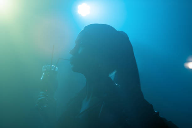 istock silhouette beautiful brunette drinking alcohol in club 1132263354