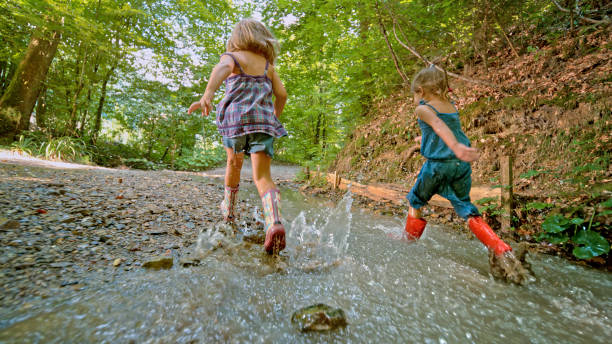 istock Girls playing in water 1132263959